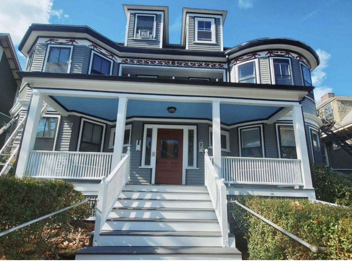 Victorian house exterior in two-tone blue with white porch