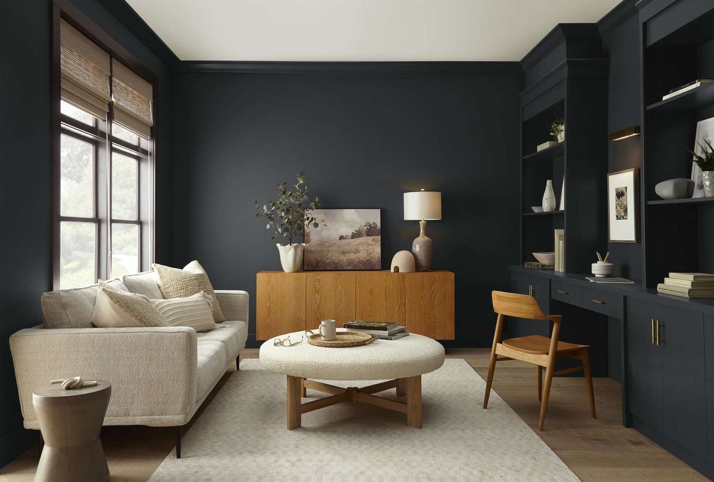 Living room painted in deep navy with built-ins