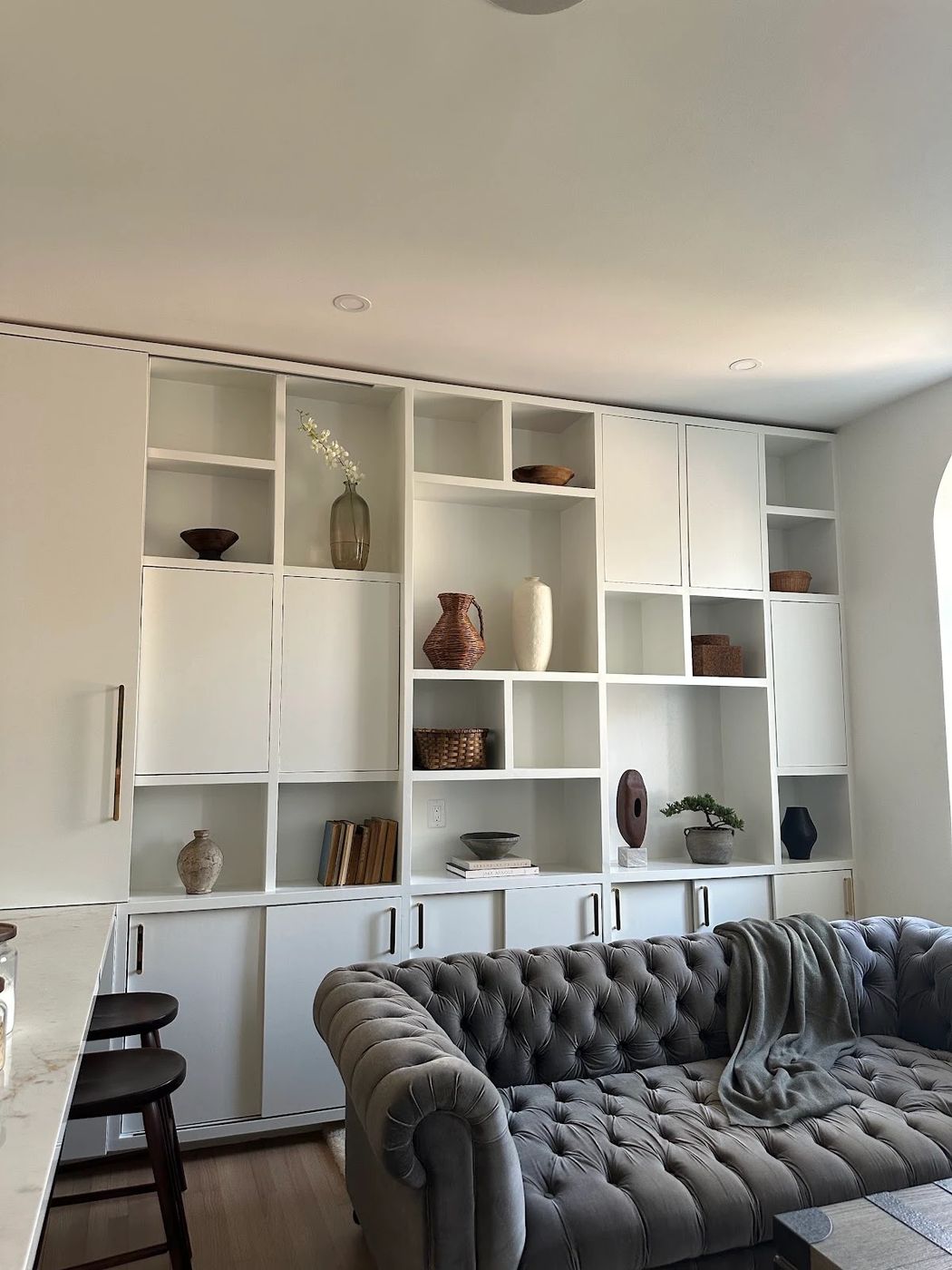 White built-in shelving with gray back panels in an office